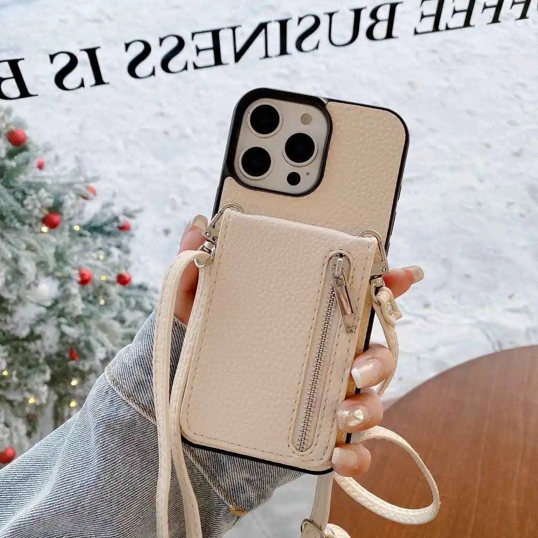 Ivory Phone case with card holder and strap held by a person, Christmas tree in the background