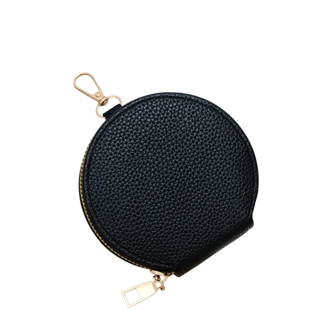 Black round coin purse with gold zipper and key ring on a white background
