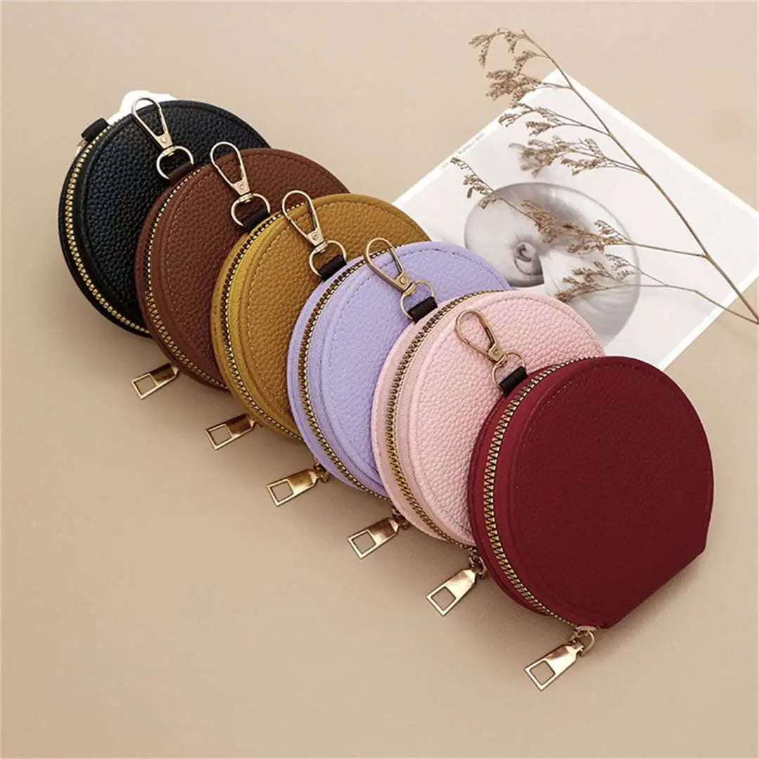 Set of round leather coin purses in various colors on a beige background