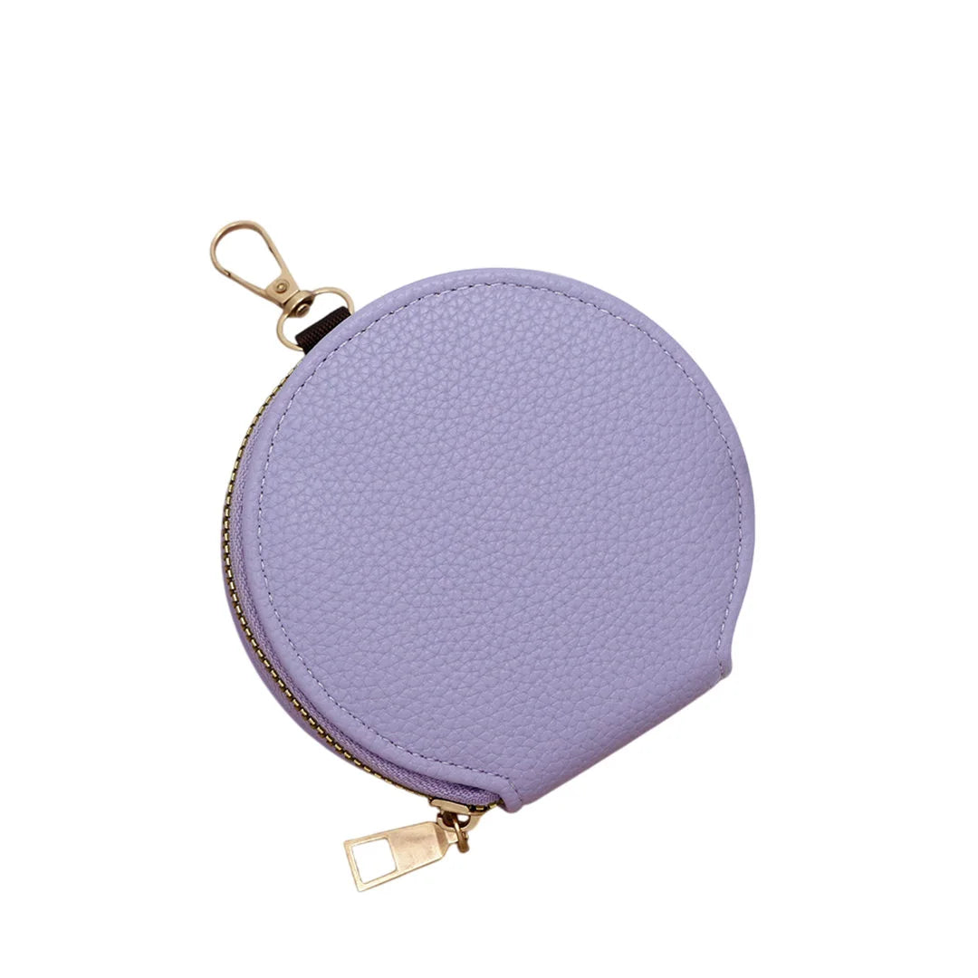 Purple round coin purse with gold zipper on a white background