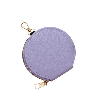 Purple round coin purse with gold zipper on a white background