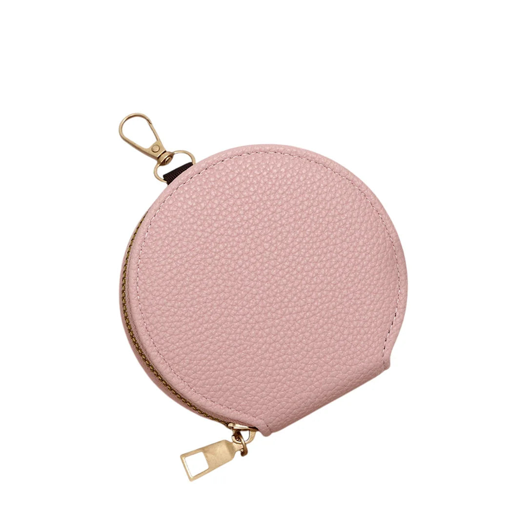 Pink round pouch with gold zipper and clasp on a white background