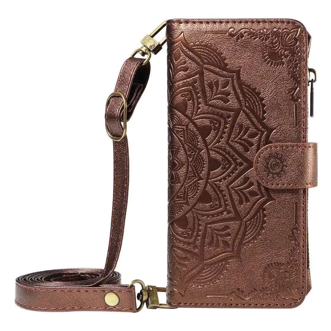 Brown leather wallet phone case with intricate patterns and a strap on a white background