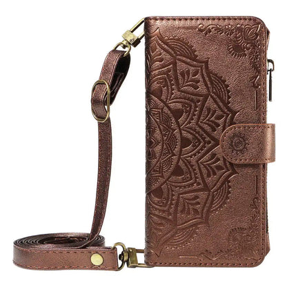 Brown leather wallet phone case with intricate patterns and a strap on a white background