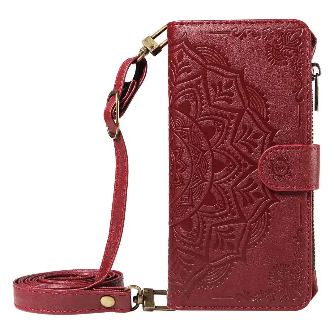 Red leather wallet phone case with intricate patterns and a strap on a white background