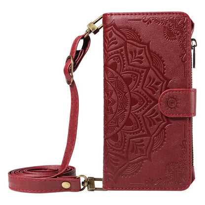 Red leather wallet phone case with intricate patterns and a strap on a white background