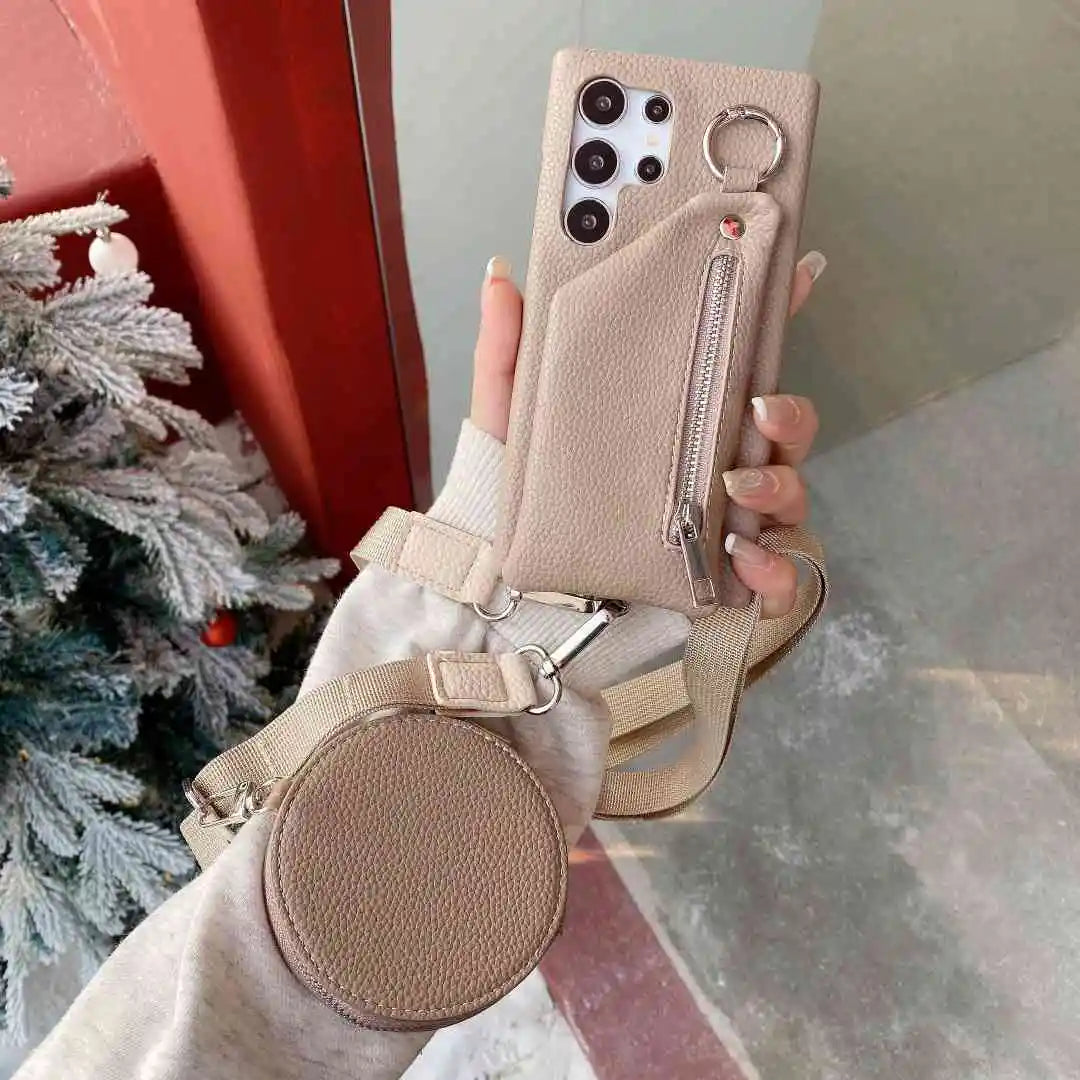 Tan wallet phone case with pouch and strap held by a hand, Christmas tree in the background