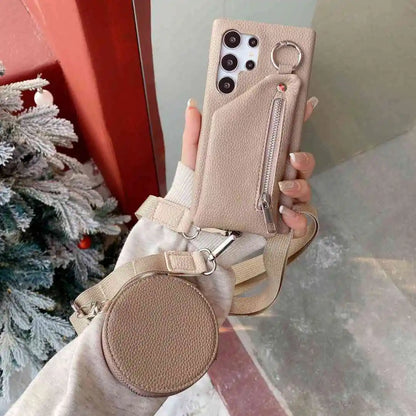 Tan wallet phone case with pouch and strap held by a hand, Christmas tree in the background