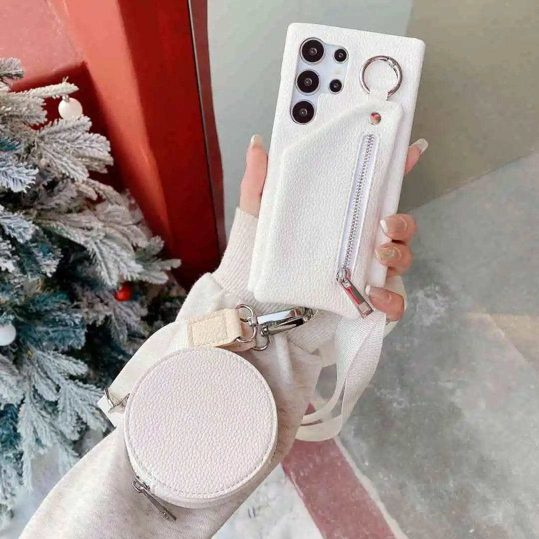 White phone case with a matching round pouch held by a hand against a blurred indoor background.