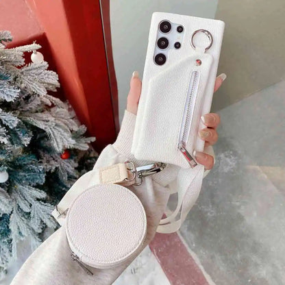 White phone case with a matching round pouch held by a hand against a blurred indoor background.