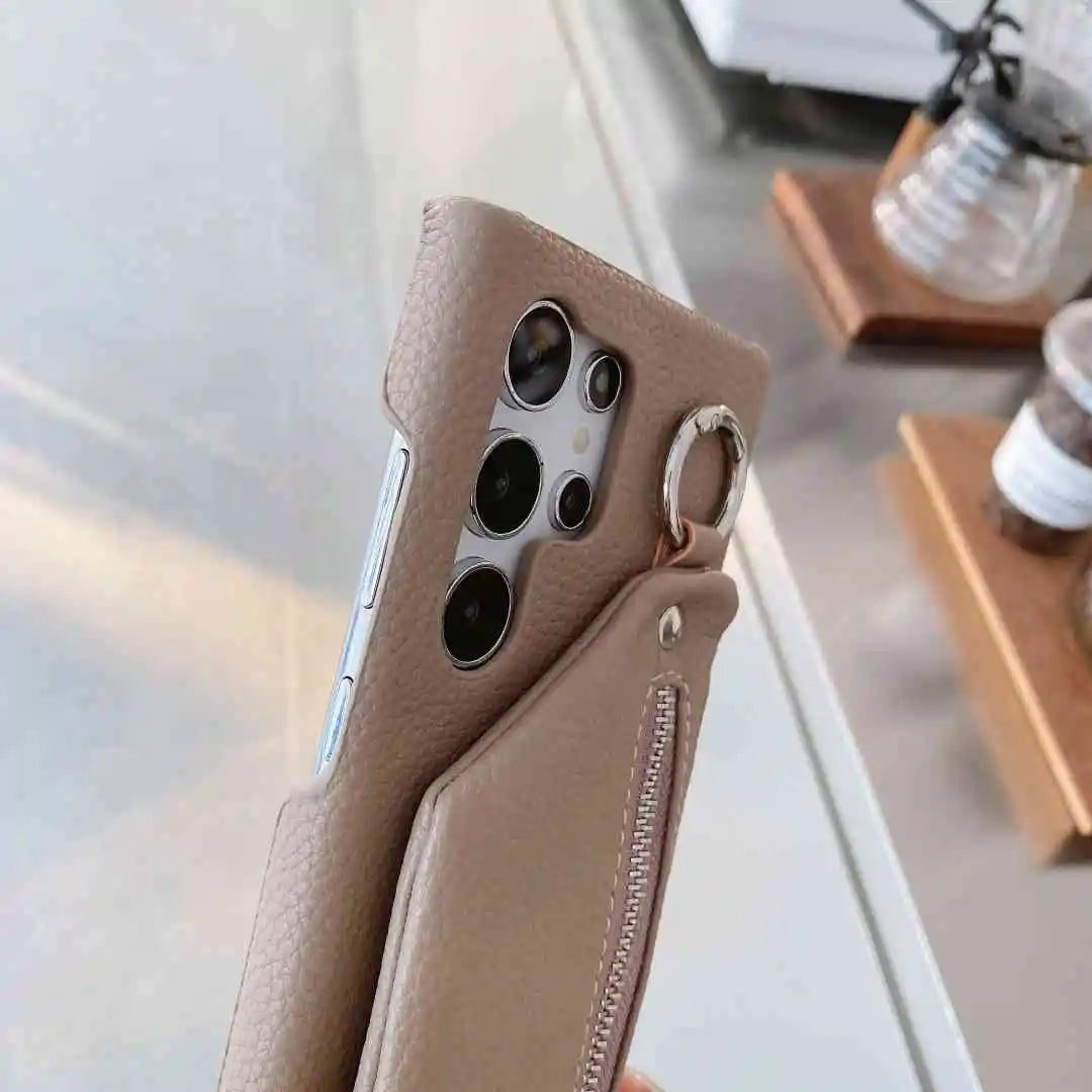 Phone case with keychain attachment on a blurred indoor background
