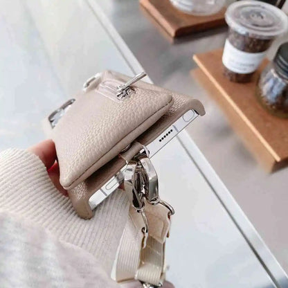 tan wallet phone case held by a hand with a blurred background