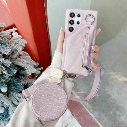 purple phone case with matching pouch held by a hand in front of a Christmas tree.