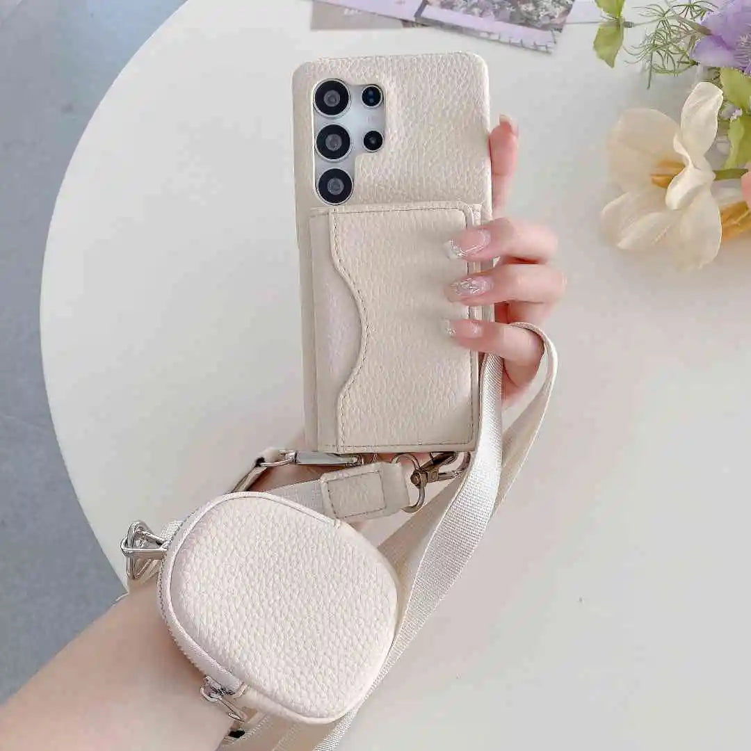 Hand holding a beige phone case with a matching pouch and strap on a light surface with flowers.