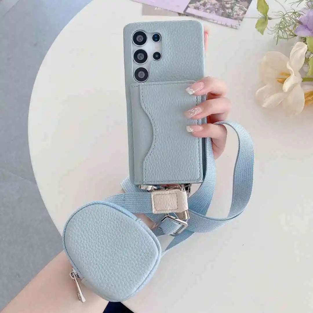 Light blue phone case with a matching strap and pouch held by a hand on a light background