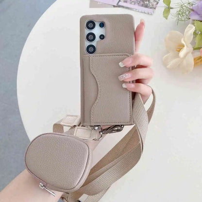 Taupe wallet phone case with strap held by a hand on a light background