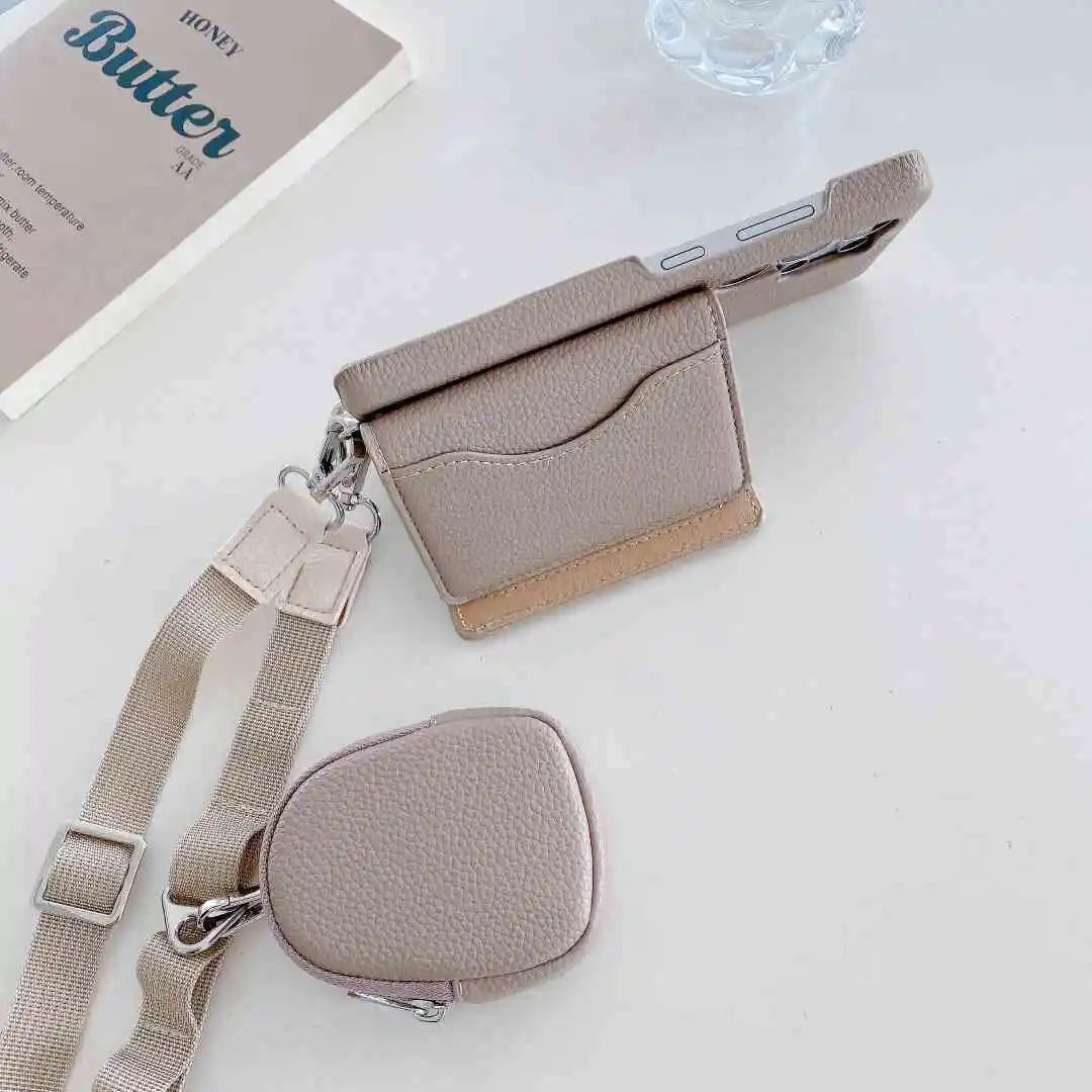 leather wallet phone case with strap and small pouch on a light surface