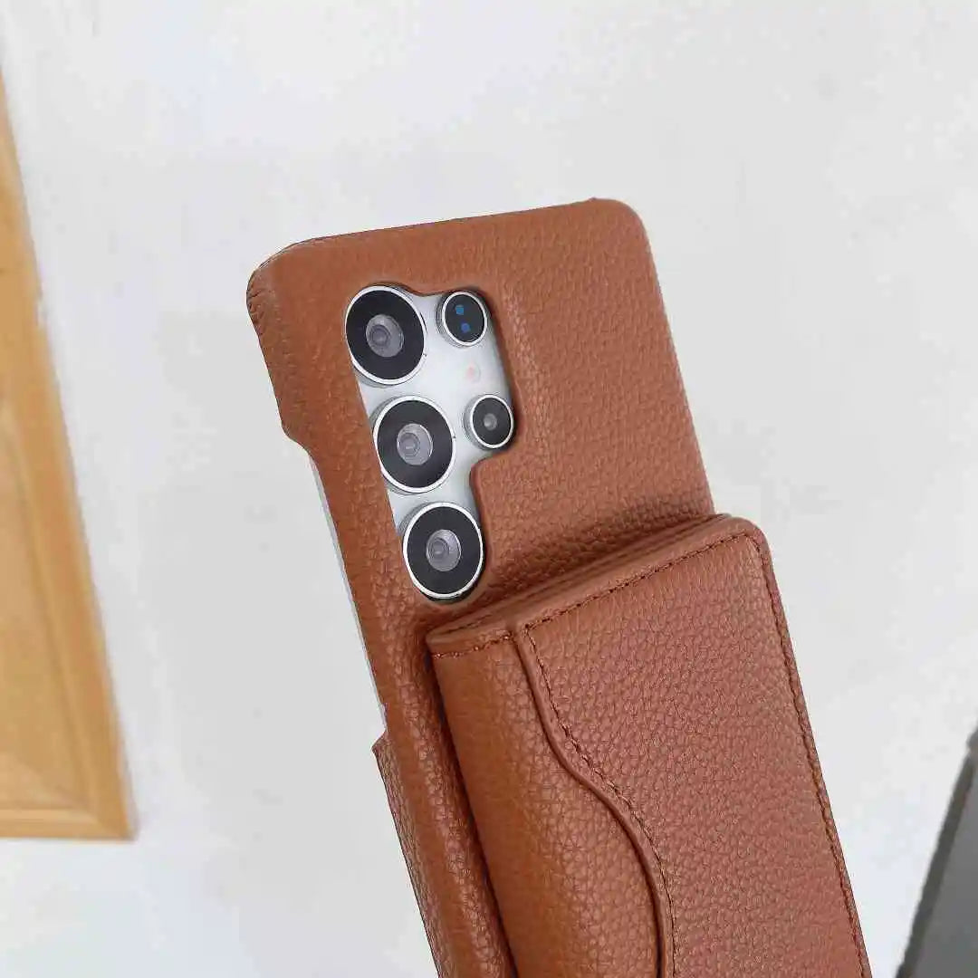 Brown wallet phone case with a Galaxy phone inside on a white background