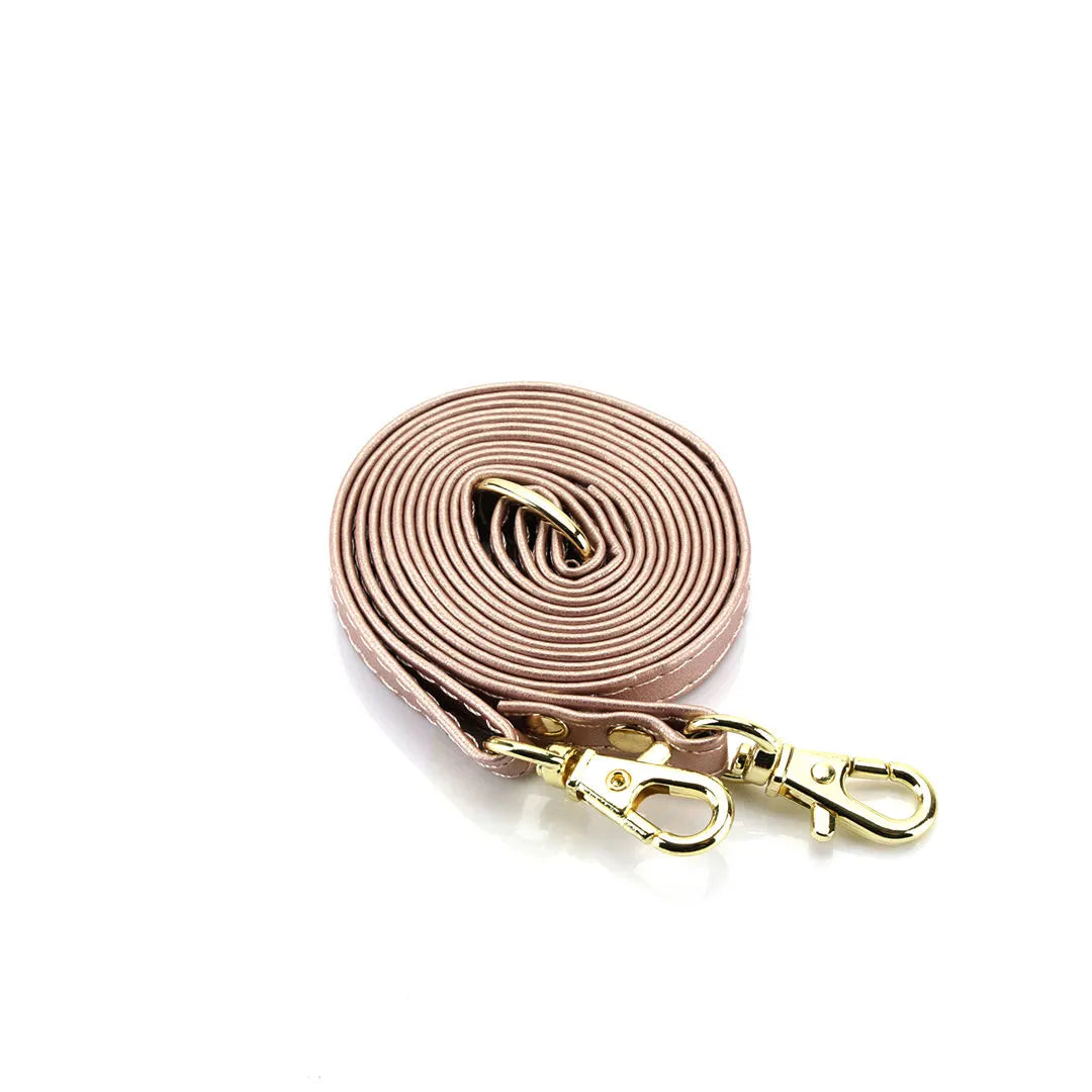 crossbody strap with gold clasp on a white background