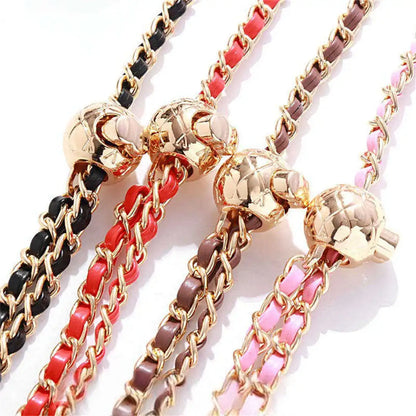 Set of colorful chain bracelets with gold clasps on a white background