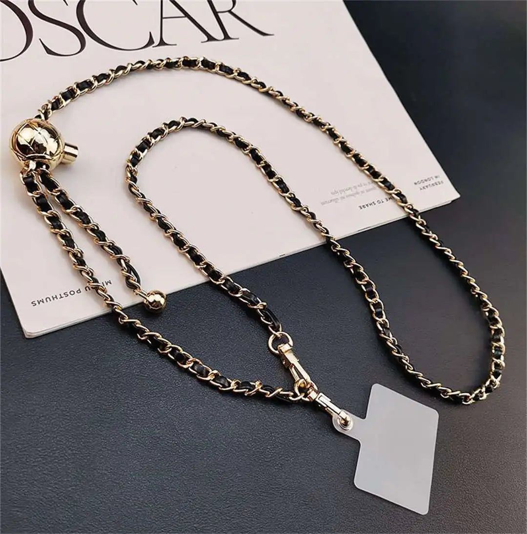 crossbody phone strap with tether tab on a dark surface
