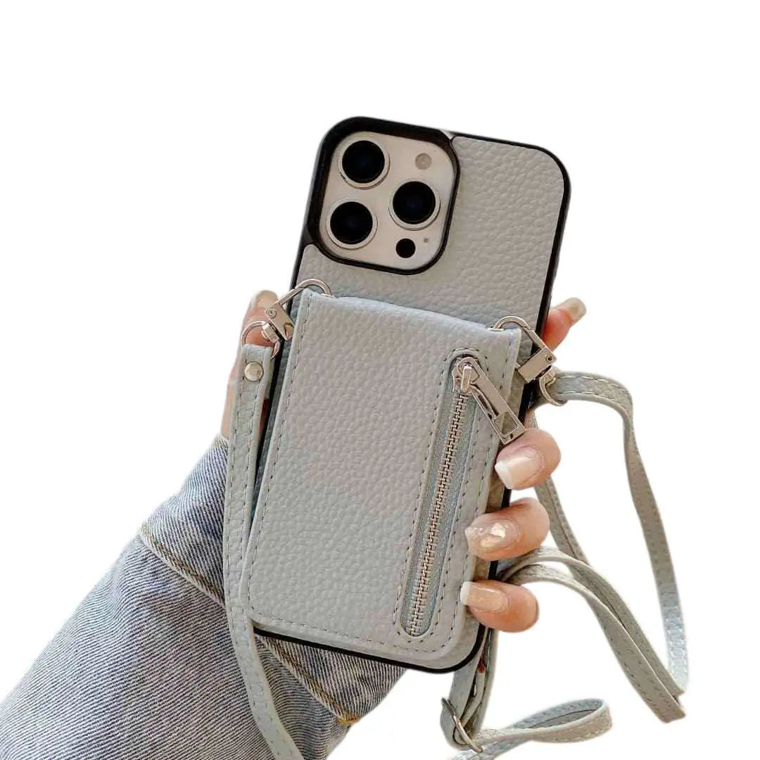 Dusty blue Phone case with a detachable strap held by a hand on a white background