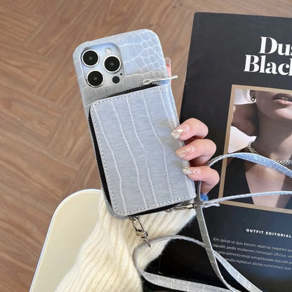 crossbody Phone case with card holder held by a hand, with a book in the background