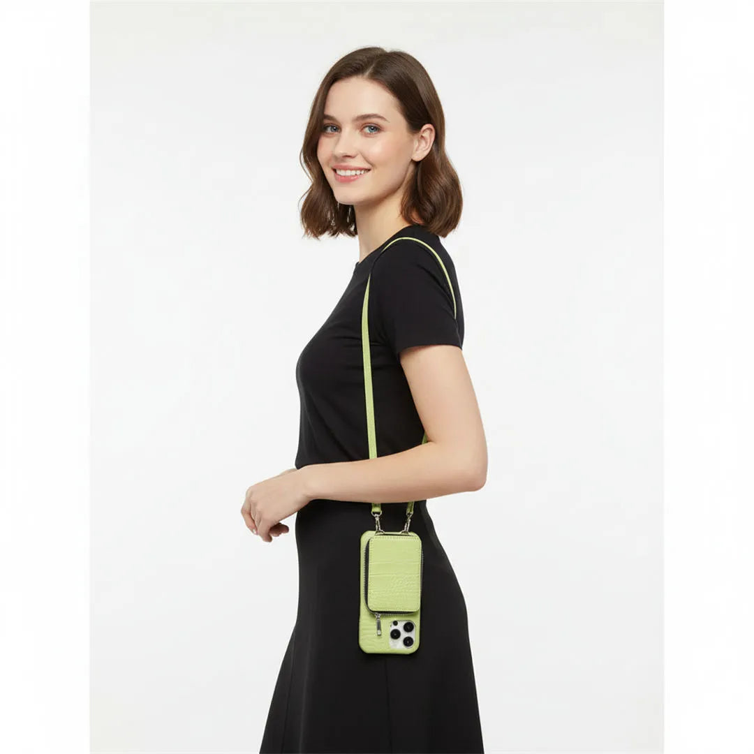 Woman wearing a black outfit with a green crossbody wallet case on a white background