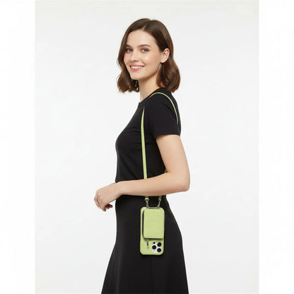 Woman wearing a black outfit with a green crossbody wallet case on a white background