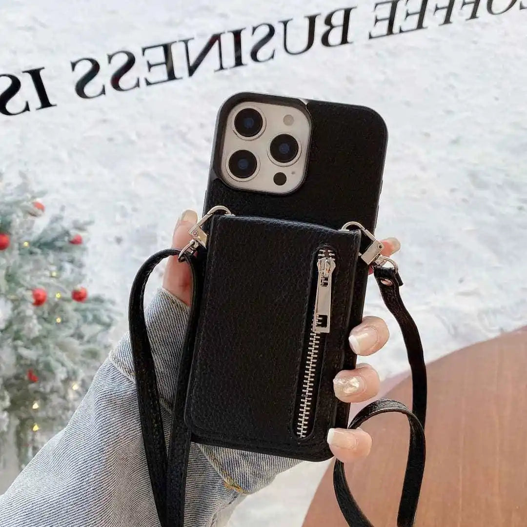 Black leather phone case with a strap held by a hand against a blurred background