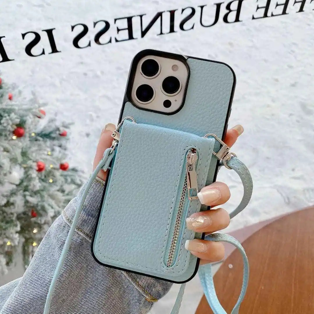 Light blue phone case with a zipper pocket held by a hand against a blurred festive background.