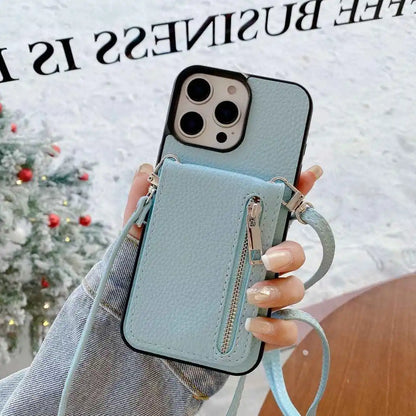 Light blue phone case with a zipper pocket held by a hand against a blurred festive background.
