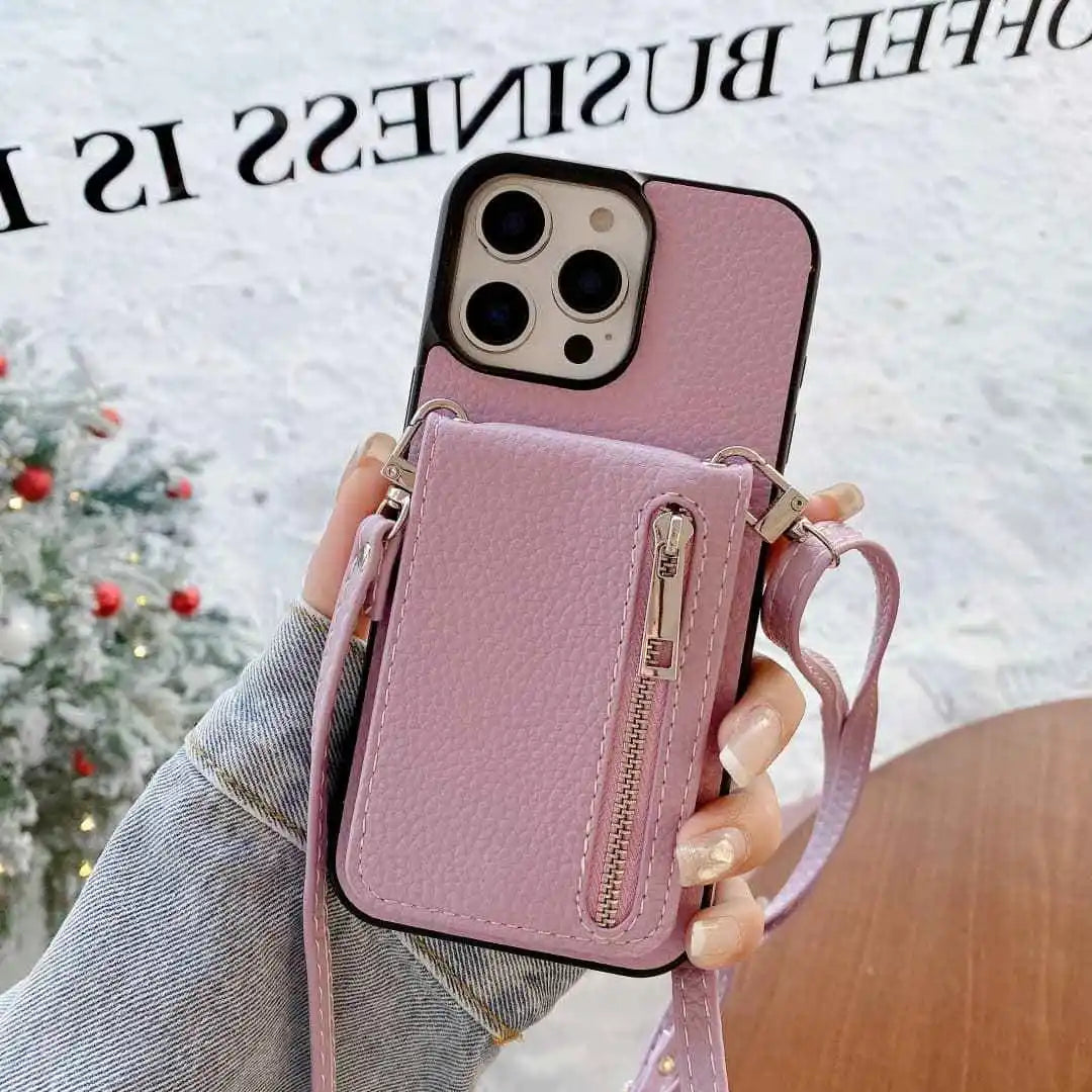 Lavender phone case with card holder and strap held by a hand, Christmas tree in the background.