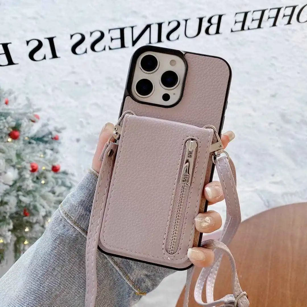 Phone case with card holder and strap held by a person, Christmas tree in the background