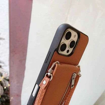 Phone case with a brown leather wallet attachment on a blurred background