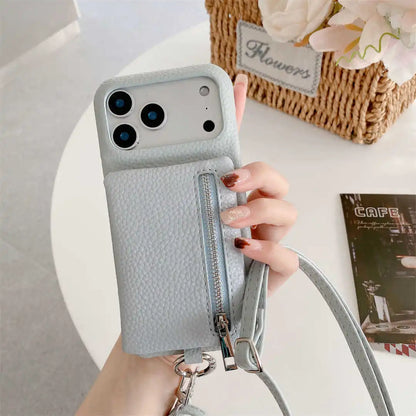 Hand holding a light blue phone case with a zippe wallet and strap