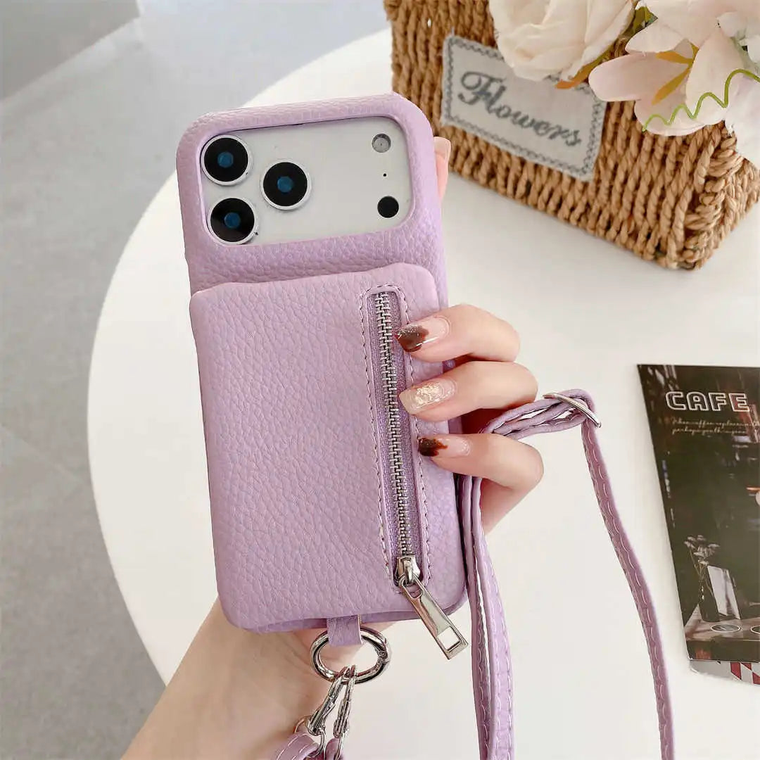 Purple phone case with a zipper wallet and srap held by a hand on a light surface.