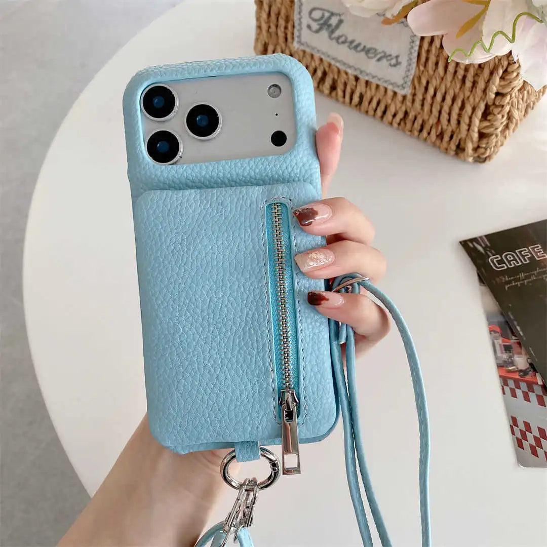 Blue phone case with a zipper wallet and crossbody strap held by a hand on a light background