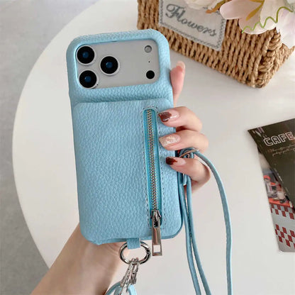 Blue phone case with a zipper wallet and crossbody strap held by a hand on a light background