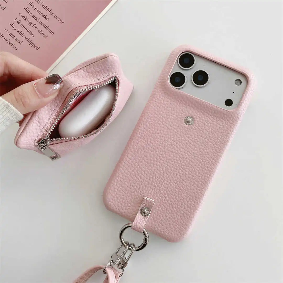 Pink leather phone case with keychain and card holder on a white surface