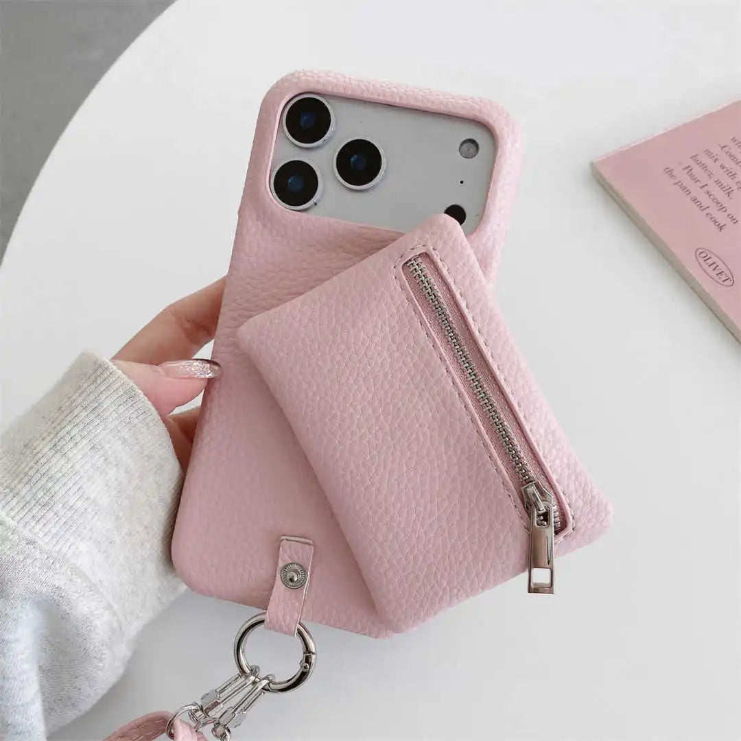 Pink phone case with zipper wallet and keychain held by a hand on a light background