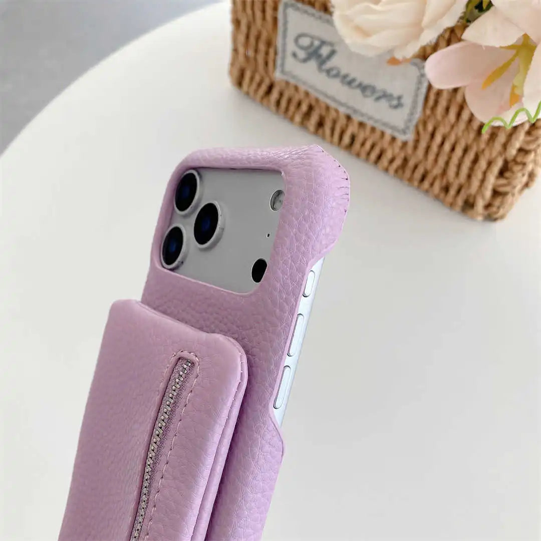 Purple phone case with a zipper wallet on a white surface with flowers in the background