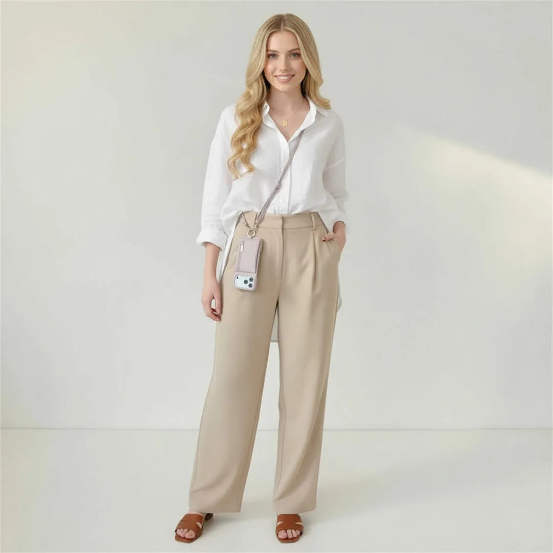 Woman wearing the crossbody wallet case against a plain background