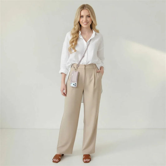 Woman wearing the crossbody wallet case against a plain background