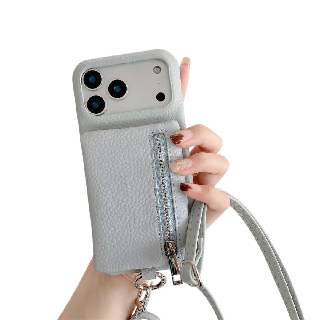 Hand holding a dusty blue phone case with a zipper pocket on a white background