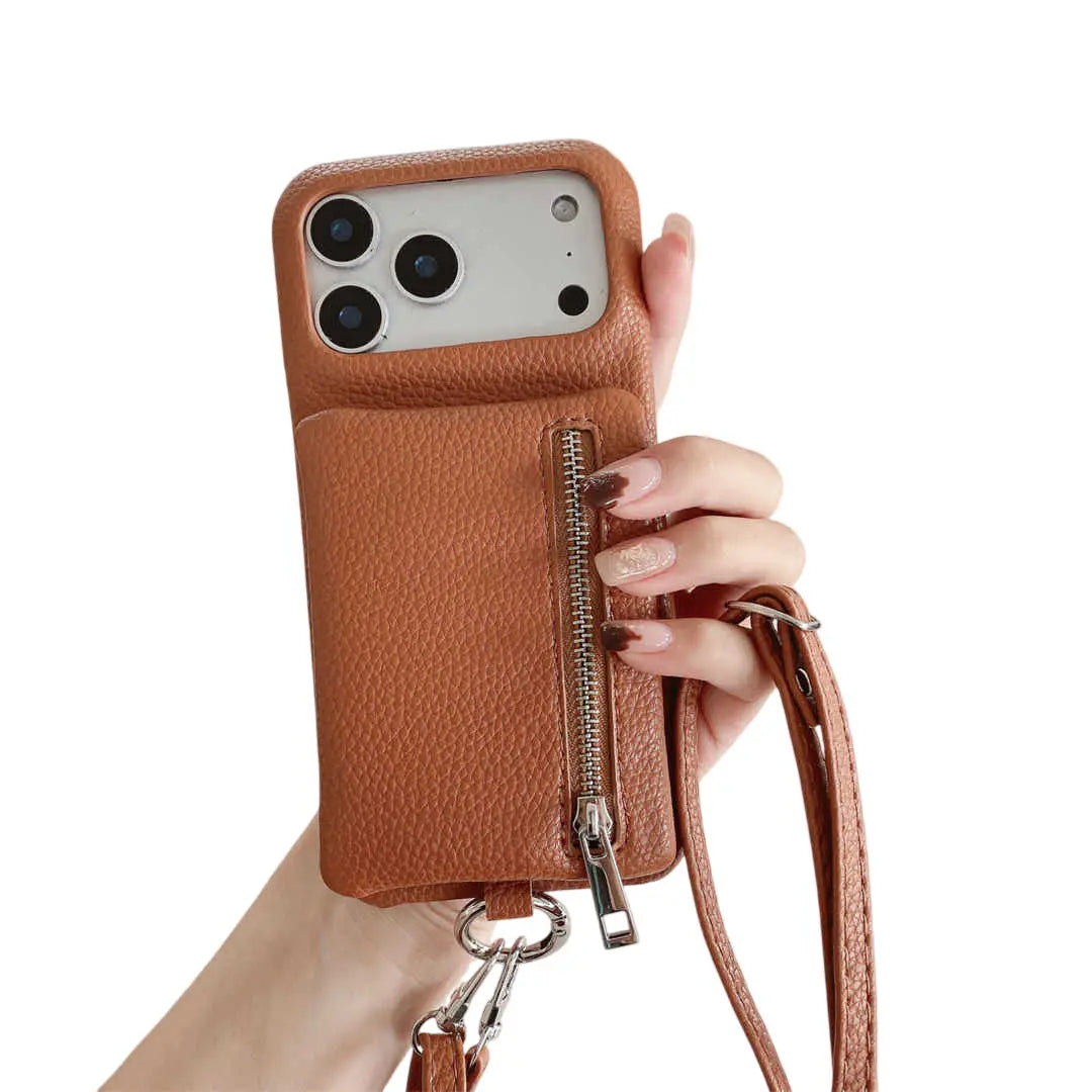 Brown leather phone case with a zipper and strap held by a hand on a white background