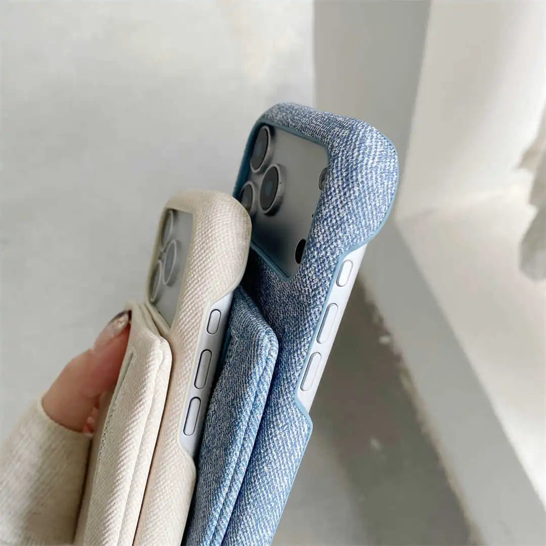 Two phone cases, one beige and one blue, held against a light background.