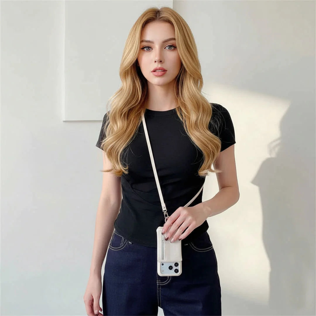 Woman holding a phone case against a plain background