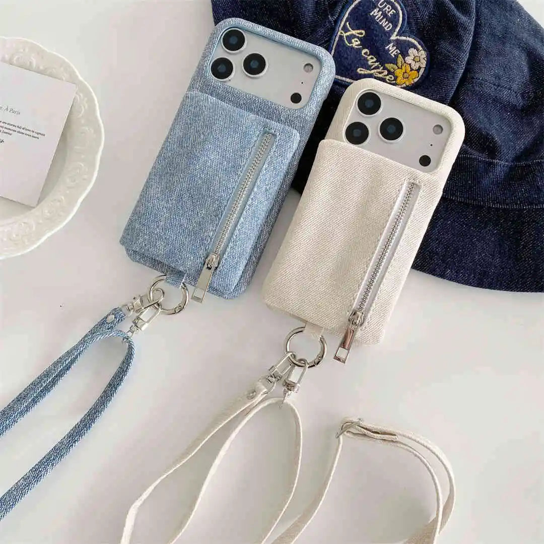 Two wallet phone cases with cross body straps on a white surface