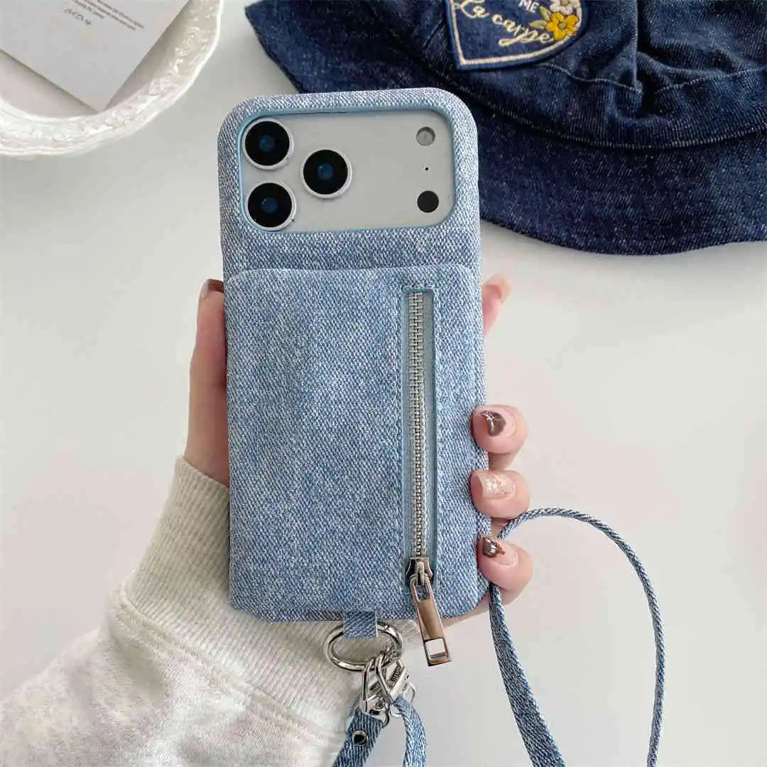 Blue denim-style crossbody phone case with a zipper wallet held by a hand on a light background